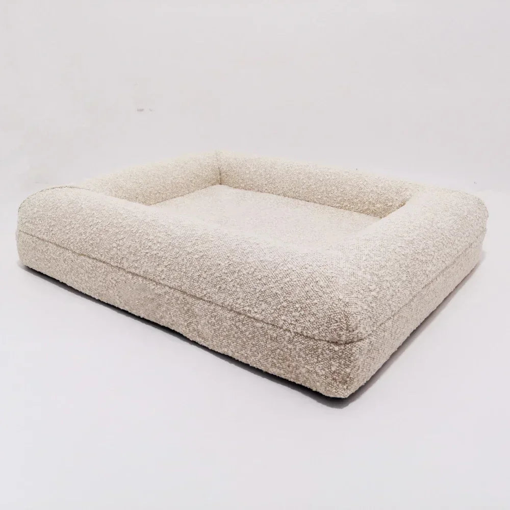 Beige pet bed on a white background