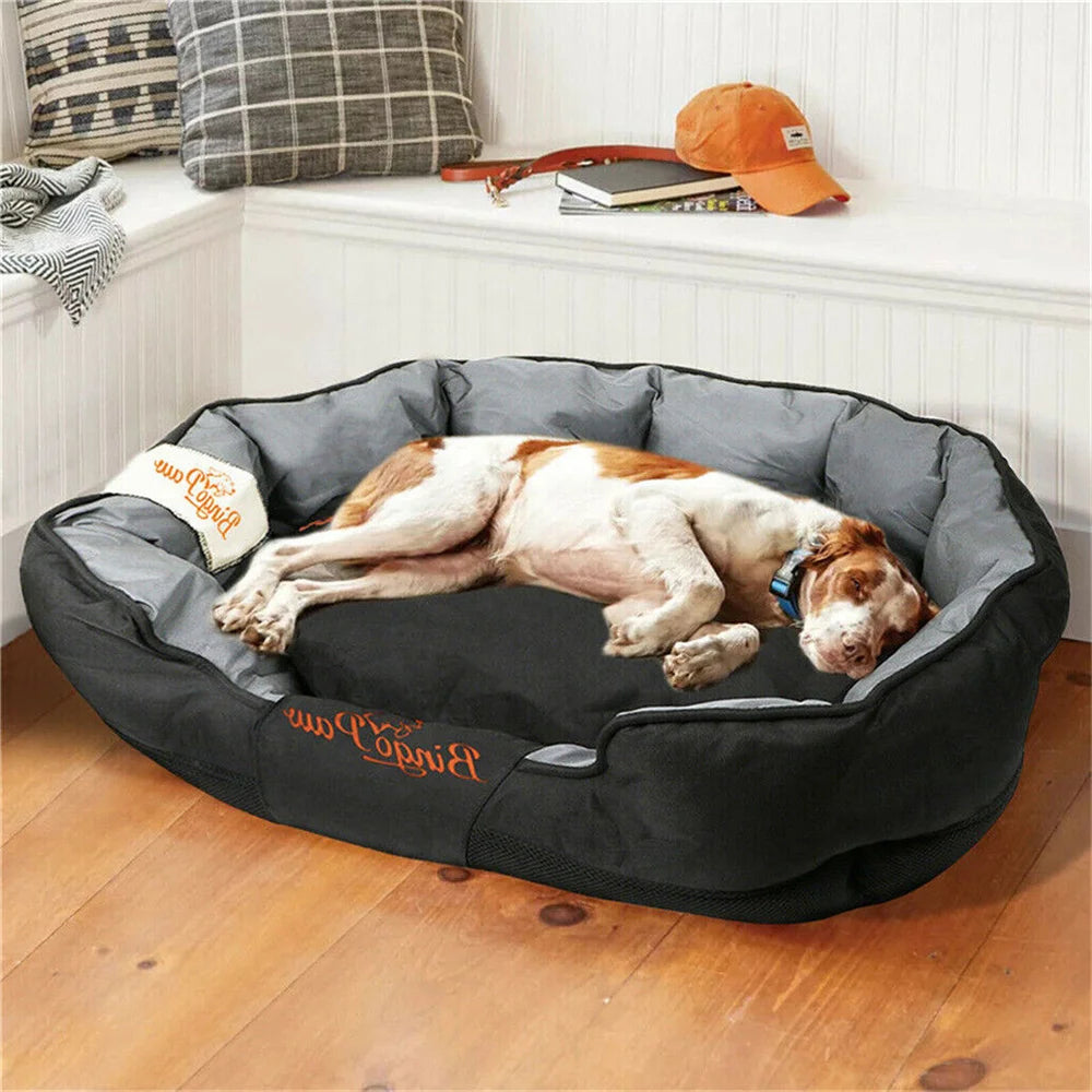 Dog lying on a large black and gray Waterproof Orthopedic Dog bed in a cozy room.