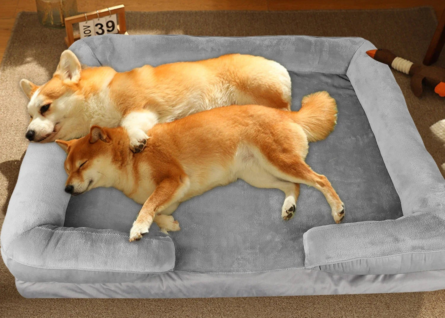 Two dogs lying on a large gray Orthopedic Dog Sofa