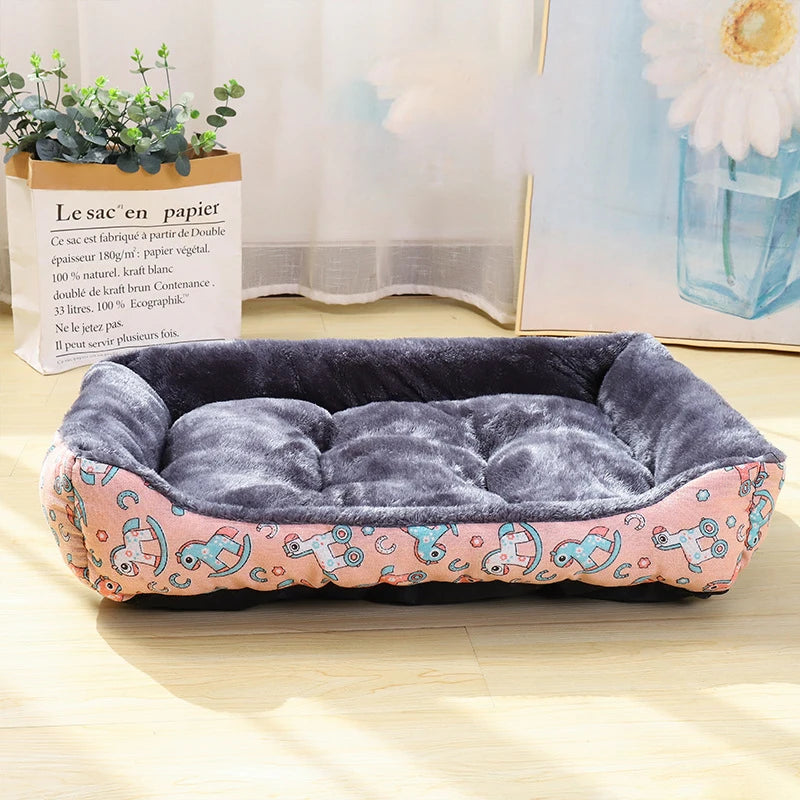 Pet bed with pink and blue design on a wooden floor