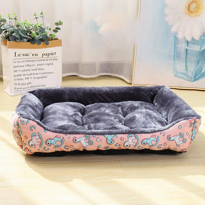 Pet bed with pink and blue design on a wooden floor